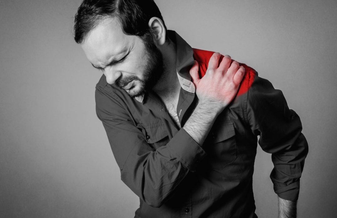 bearded man has a shoulder pain
